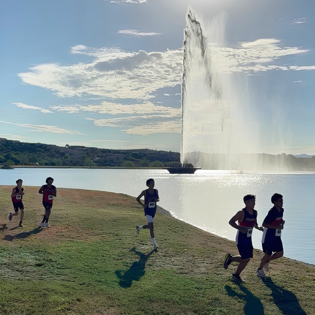Runners at Desert Twilight in front of fountain