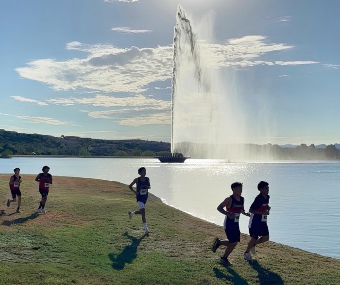 Runners at Desert Twilight in front of fountain